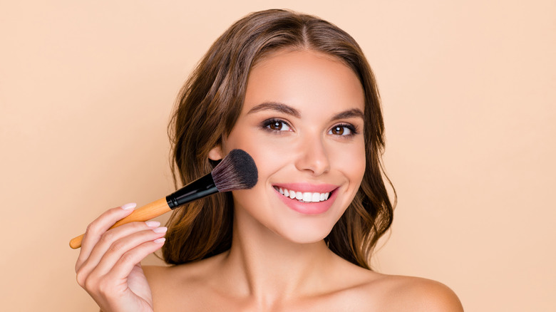 Add pink blush on cheeks and nose