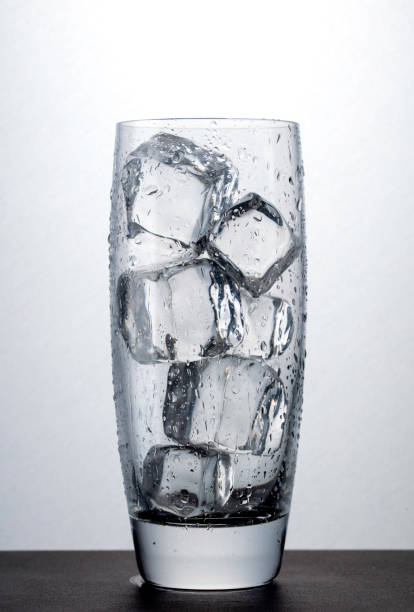 Fill a glass with ice cubes.