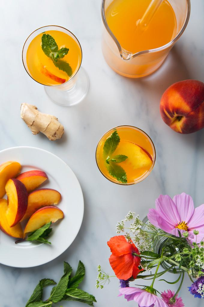 Garnish with a peach slice and fresh mint.
